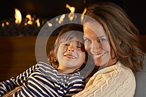Portrait mother and son by firelight