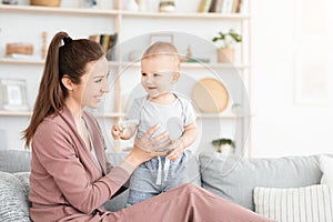 Portrait Of Mother And Toddler Baby Playing And Laughing Together At Home