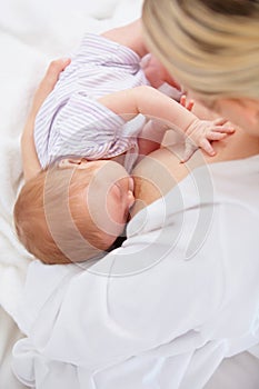 Portrait of motherhood. High angle shot of a mother breastfeeding her newborn baby.