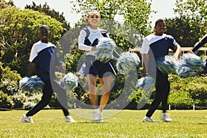 Portrait, motivation and a cheerleader team of young people outdoor for a training routine or sports event. Smile