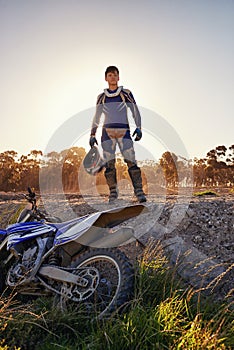 Portrait, motocross and rider by dirtbike in forest, confident and extreme sport for adventure with speed. Man, pride or