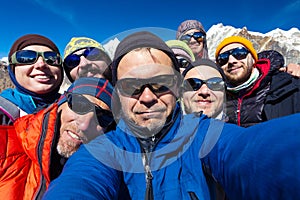 Portrait of Mountain Climbers Team happy to reach the Summit