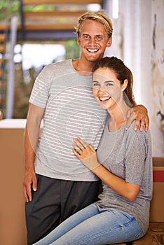 Portrait, moving and happy couple for real estate, new home and property investment in hallway of house. Mortgage loan