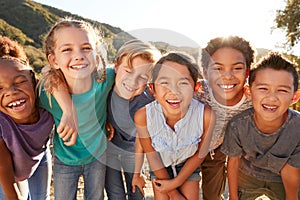 Portrait Of Multi-Cultural Children Hanging Out With Friends In Countryside Together photo