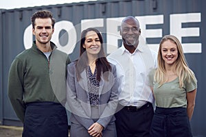Portrait Of Multi-Cultural Freight Haulage Team Standing By Shipping Container photo
