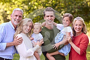 Portrait Of Multi-Generation Family Enjoying Walk In Countryside Together 