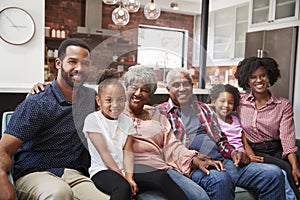 Portrait Of Multi Generation Family Relaxing On Sofa At Home Together