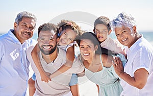 Portrait of multi generation family on vacation at the beach together. Mixed race family with two children, two parents