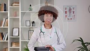 Portrait of multicultural female doctor posing at modern hospital office