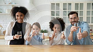 Portrait of multiracial family with kids drink water