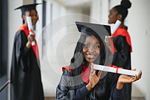 Portrait of multiracial graduates holding diploma