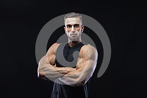 Portrait of a muscular male model against black background