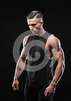Portrait of a muscular male model against black background