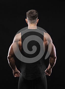 Portrait of a muscular male model against black background