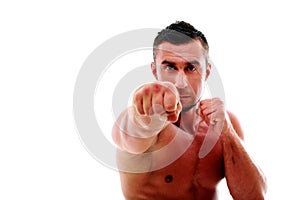 Portrait of a muscular man punching camera