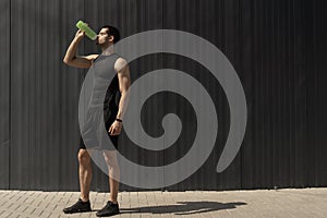 Portrait muscular man taking a break to hydrate his body after