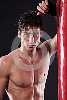 Portrait, muscular and man with training, boxing and fitness on a dark studio background. Face, person and model with