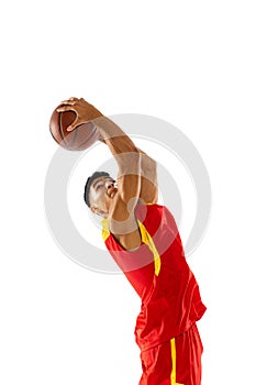 Portrait of muscular young man, basketball player scoring winning goal isolated over white studio background