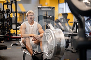 portrait Muscular young man training at gym, confident bodybuilder working out with weights in sport club, bodybuilding