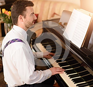 Portrait of music performer playing his piano