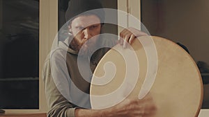 Portrait of musician playing a frame drum