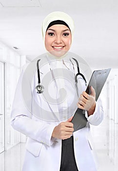 Moslem asian doctor writing on paperclip