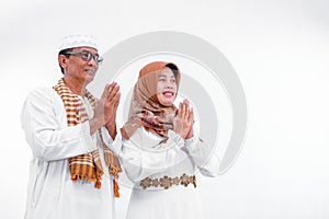 Portrait of a muslim couple who greeting and smiling on isolated white background