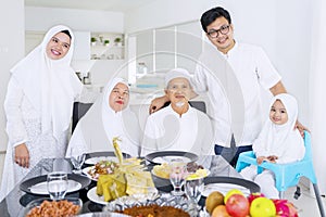 Muslim family looking at camera together at home photo