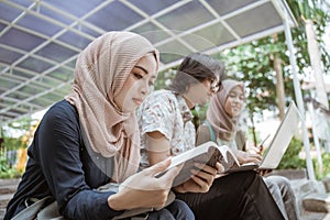 Portrait Muslim female student reading a book.