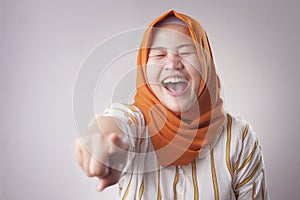 Muslim Lady laughing Hard Bully Expression and Pointing Forward photo