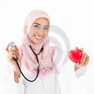 Portrait of Muslim woman doctor shows red heart