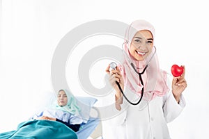Portrait of Muslim woman doctor shows red heart