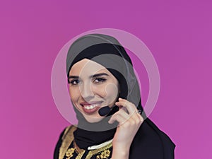 Portrait of muslim woman with headset on pink background