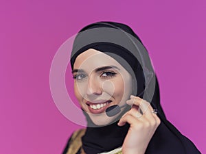 Portrait of muslim woman with headset on pink background