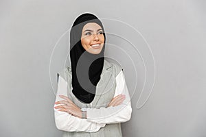 Portrait of muslim woman 20s in traditional scarf smiling and lo