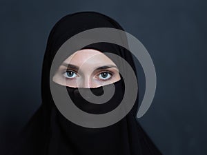 Portrait of muslim woman wearing niqab and traditional arabic clothes or abaya