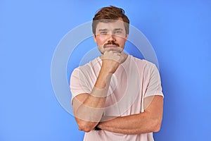 Portrait of mysterious man isolated over blue background