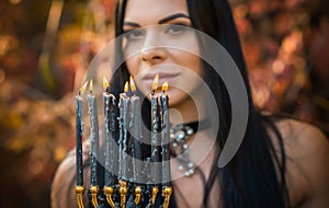 Portrait of mystical woman with a candle, rituals concept