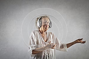 Portrait of n aged woman listening to music