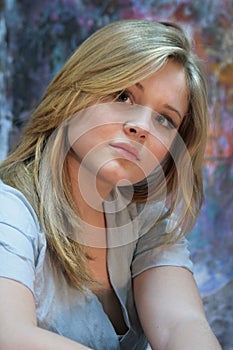 Portrait of a natural blonde. Teen girl on a colorful background