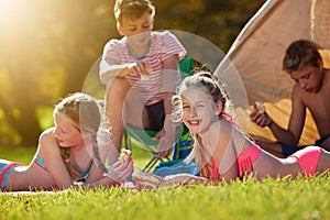 Portrait, nature and children in tent for camping in forest for vacation, holiday or adventure. Travel, friends and