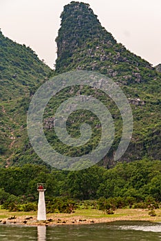 Portrait of Navigation Beacon with karst mountains along the Li River in Guilin, China