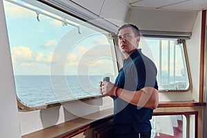 Portrait of navigator / pilot / officer on the bridge of the vessel