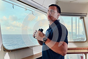 Portrait of navigator / pilot / officer on the bridge of the vessel