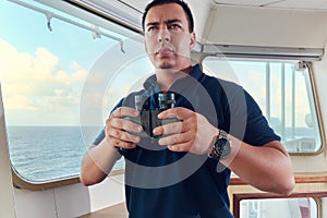 Portrait of navigator pilot officer on the bridge of the vessel