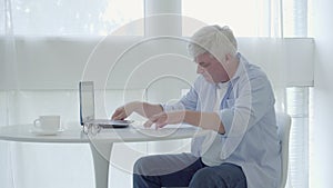 Portrait of nervous businessman dissatisfied with project. Senior man writing with pen, crumpling paper and throwing it