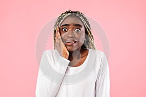 Portrait of nervous scared african american woman grabbing face