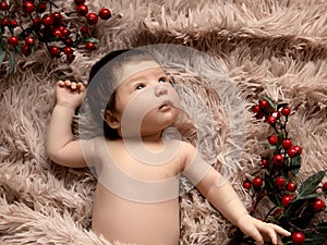 Portrait of New Born Baby. Christmas concept. Newborn baby in a wrap on biege blanket. Beautiful portrait of