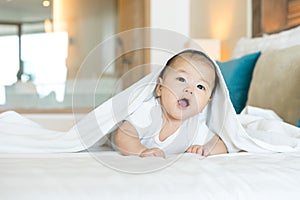 Portrait of a newborn Asian baby on the bed