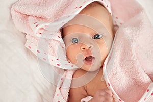 Portrait of newborn baby face with opened mouth.